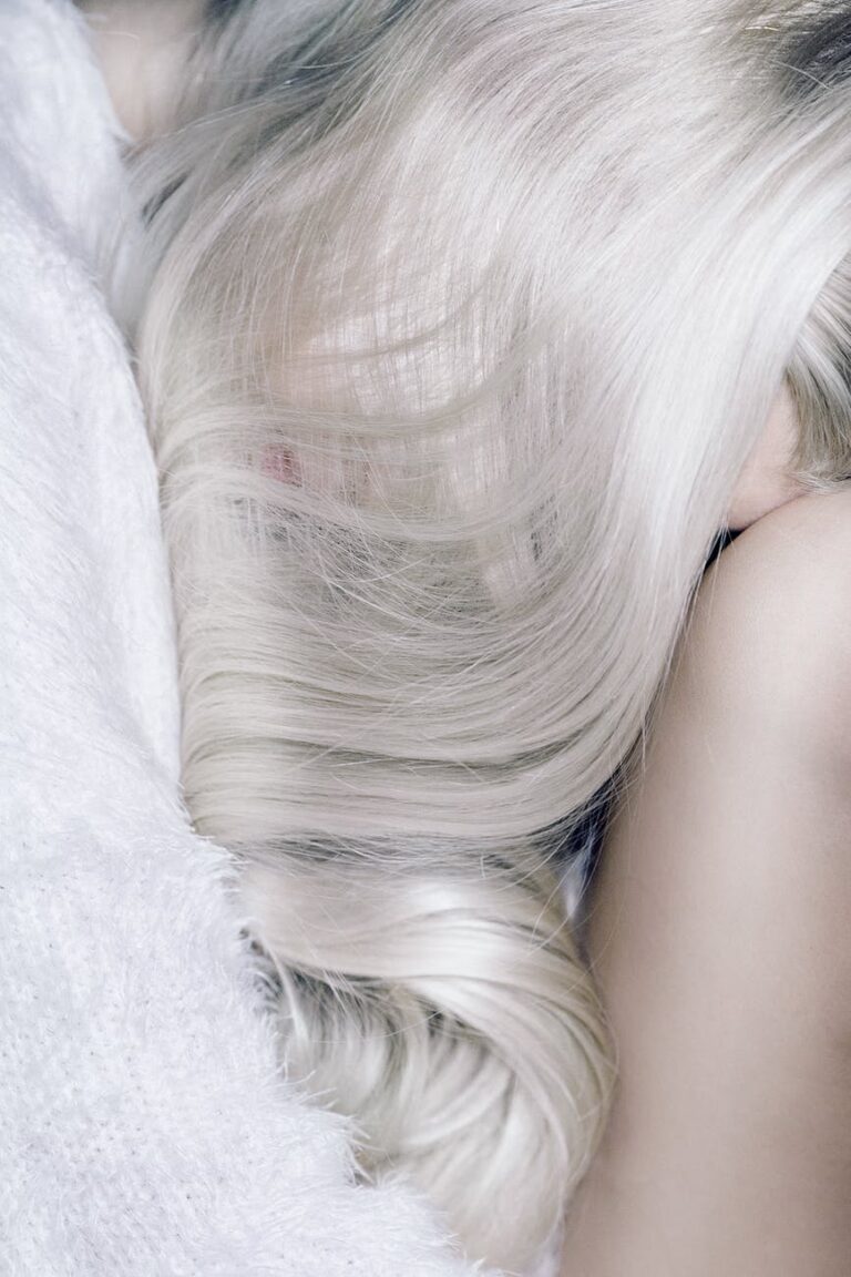 young blond woman sleeping on bed